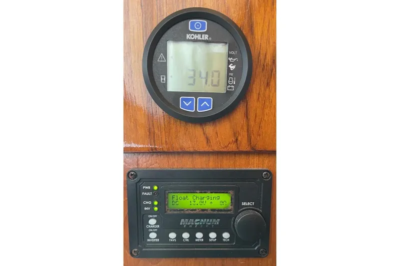 Slide: The Image of Control panel on 1986 Ocean 38 Super Sport boat, displaying voltage and charging status. - 22
