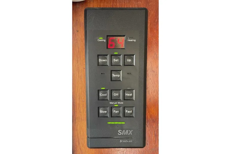 Slide: The Image of 1986 Ocean 38 Super Sport thermostat control panel with digital display and buttons. - 23