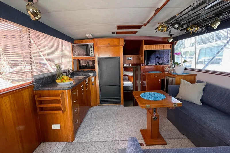 Slide: The Image of Interior of 1986 Ocean 38 Super Sport yacht with kitchen, seating, and fishing rods. - 3
