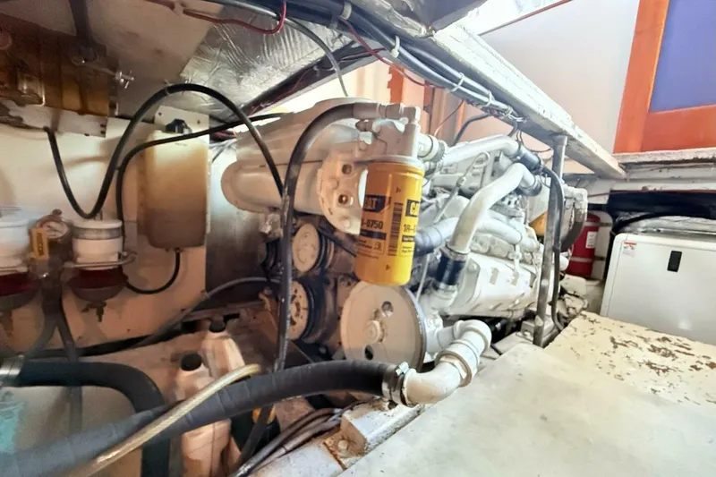 Slide: The Image of Engine room of 1986 Ocean 38 Super Sport boat, featuring detailed mechanical components. - 33