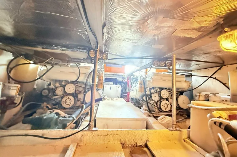 Slide: The Image of Engine room of a 1986 Ocean 38 Super Sport boat, showcasing dual engines. - 34