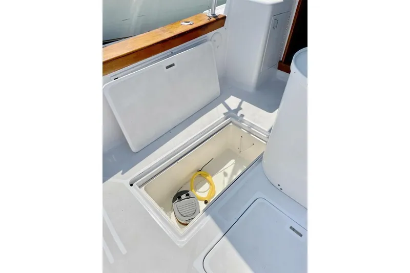 Slide: The Image of 1986 Ocean 38 Super Sport boat deck with open storage compartment. - 35
