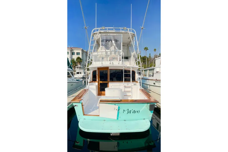 Slide: The Image of 1986 Ocean 38 Super Sport yacht docked, featuring a spacious deck and elegant design. - 39