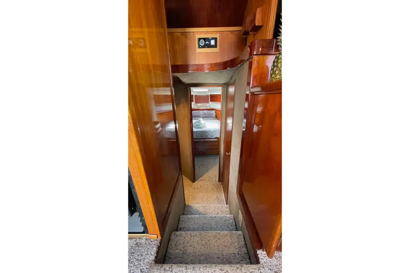 Slide: The Image of Interior of 1986 Ocean 38 Super Sport yacht with wooden paneling and carpeted stairs. - 5