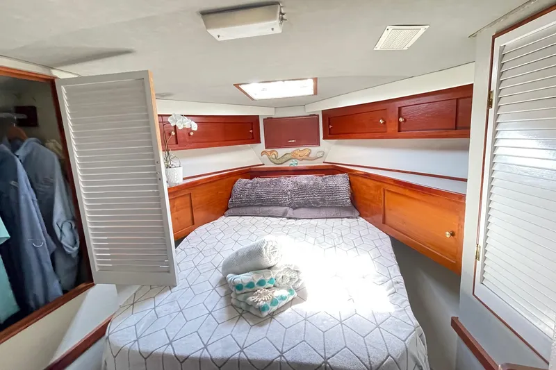 Slide: The Image of Cozy bedroom in 1986 Ocean 38 Super Sport yacht with wooden cabinets and skylight. - 7