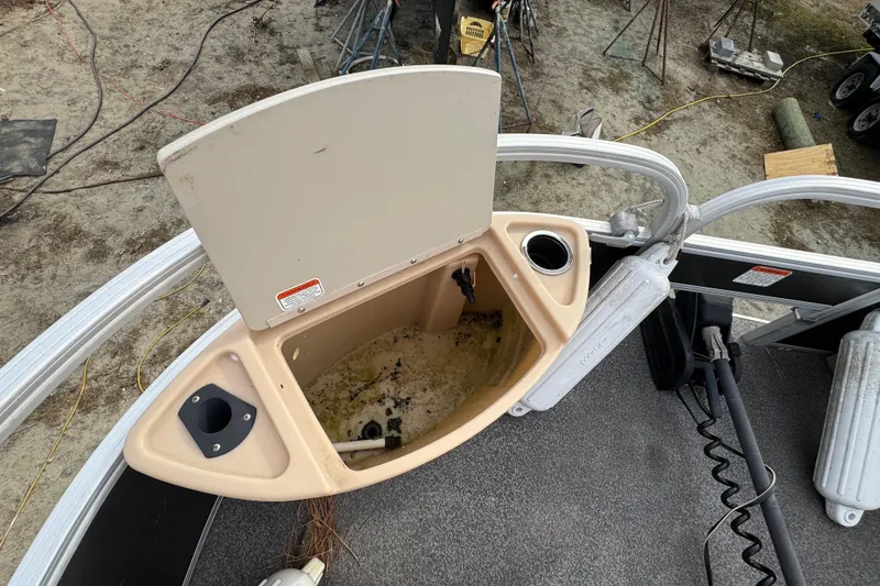 Slide: The Image of 2017 SUNTRACKER TRI-TOON boat storage compartment with open lid, showing interior details. - 30