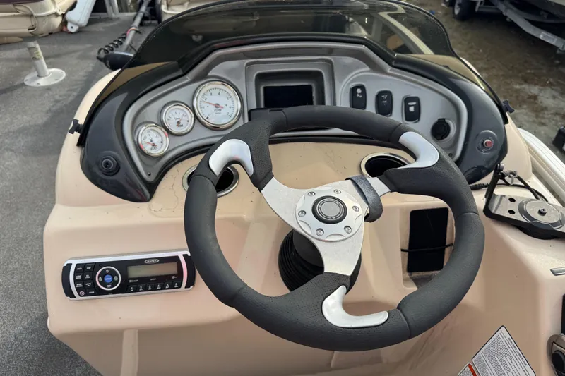 Slide: The Image of Steering console of a 2017 SUNTRACKER TRI-TOON boat with gauges and controls. - 36