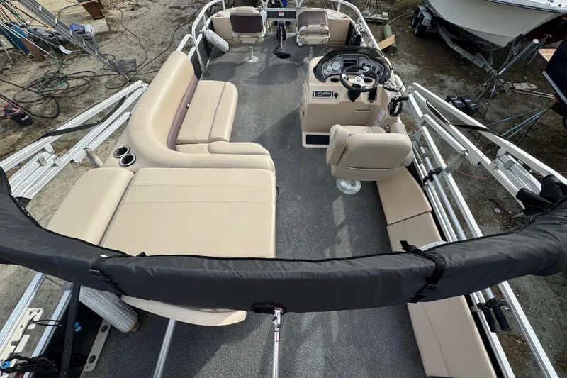 Slide: The Image of 2017 SUNTRACKER TRI-TOON boat interior with beige seating and steering console. - 41