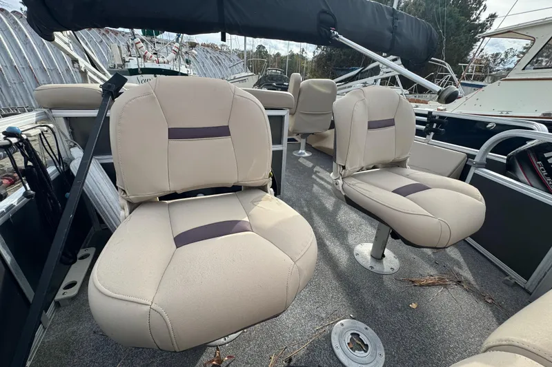 Slide: The Image of 2017 SUNTRACKER TRI-TOON boat interior with beige seating & bimini top - 42