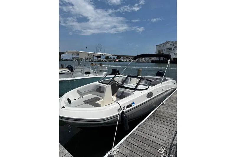 The Image of 2023 Bayliner VR6 Bowrider OB docked at marina under clear sky. - 0