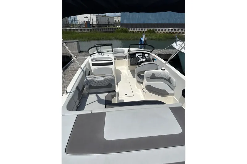 Slide: The Image of 2023 Bayliner VR6 Bowrider OB with spacious seating and modern design at a dock. - 5