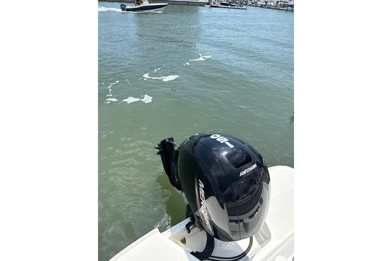 Slide: The Image of 2023 Bayliner VR6 Bowrider OB with Mercury outboard motor on calm water. - 8