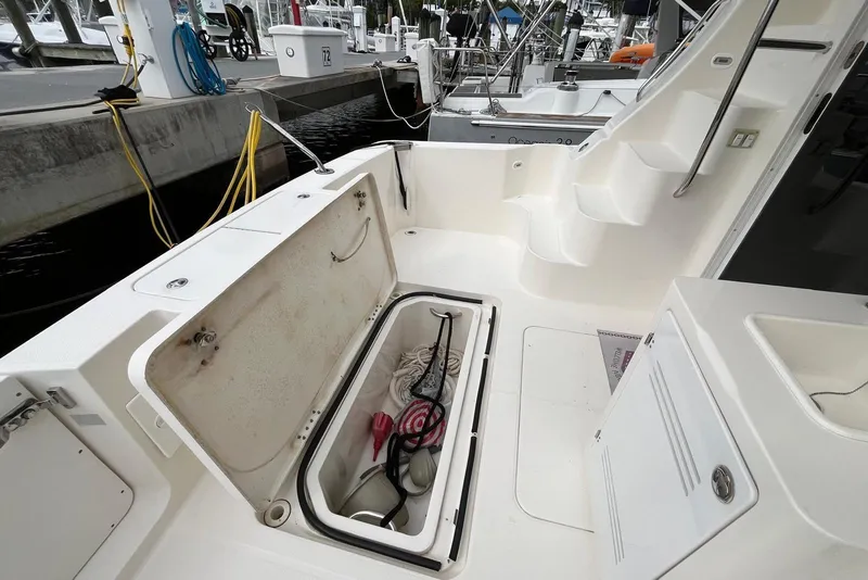 Slide: The Image of 2005 Silverton 34 Convertible boat interior with open storage compartment at marina. - 12