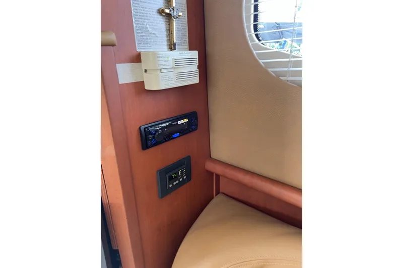 Slide: The Image of Interior of 2005 Silverton 34 Convertible with control panel and window blinds. - 13