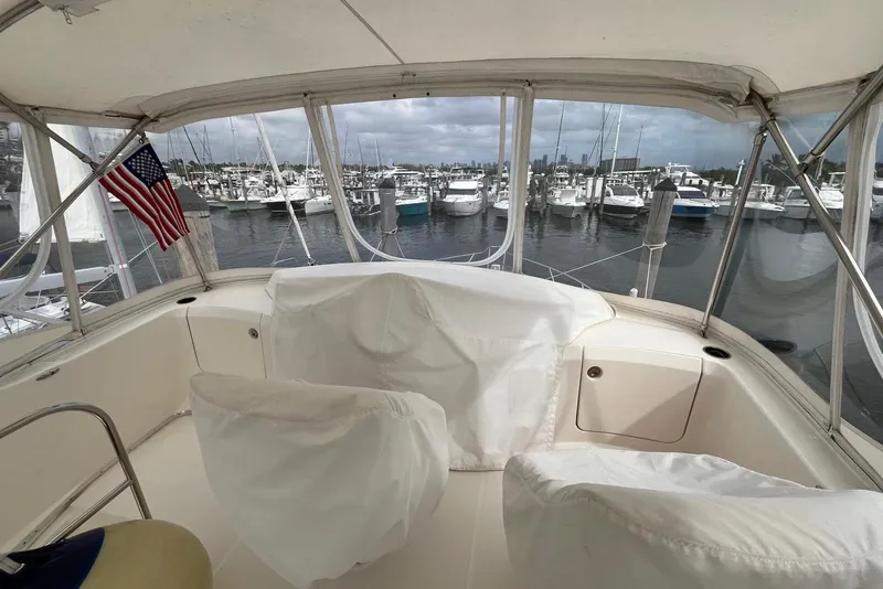 Slide: The Image of 2005 Silverton 34 Convertible yacht interior with marina view and American flag. - 15