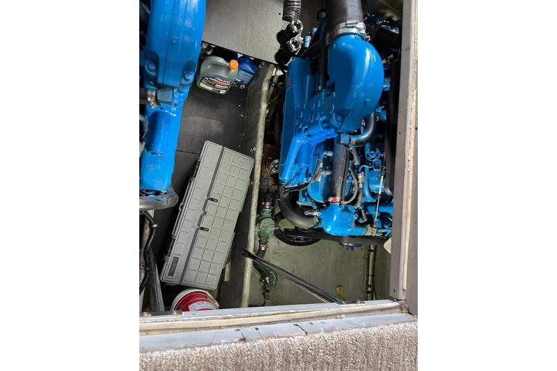 Slide: The Image of Engine compartment of a 2005 Silverton 34 Convertible boat, featuring blue engine components. - 16