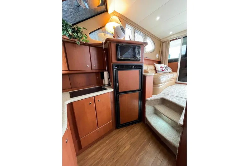 Slide: The Image of Interior of 2005 Silverton 34 Convertible yacht with kitchen and seating area. - 22