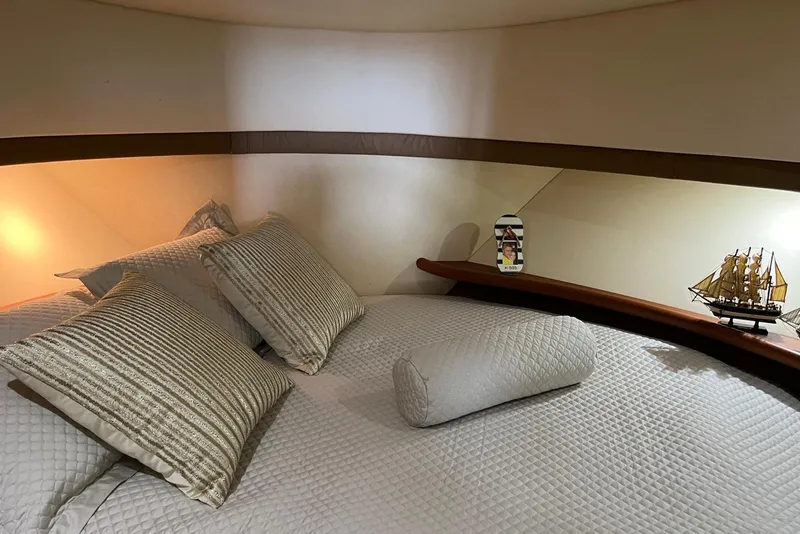 Slide: The Image of Luxurious bedroom interior of 2005 Silverton 34 Convertible yacht with elegant bedding and decor. - 23