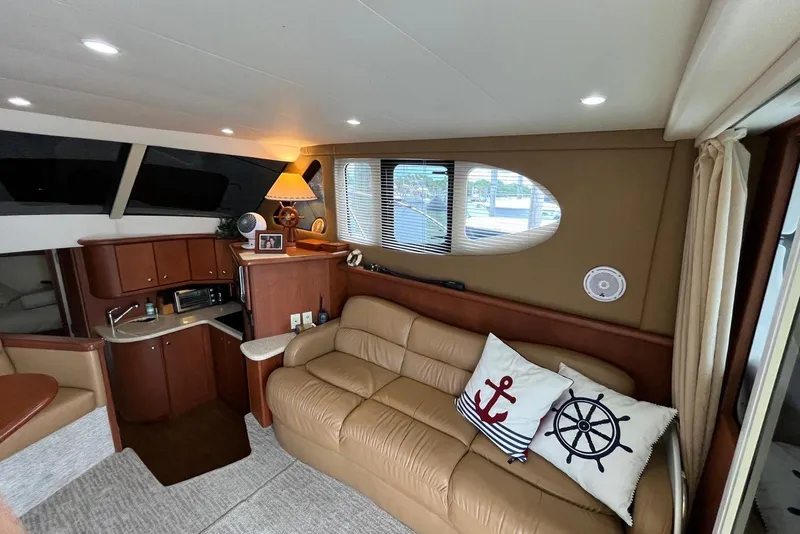 Slide: The Image of Interior of 2005 Silverton 34 Convertible yacht with cozy seating and nautical decor. - 28