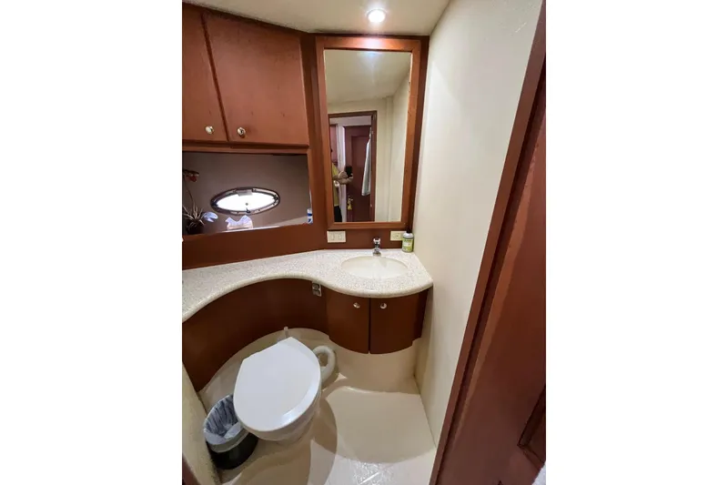 Slide: The Image of 2005 Silverton 34 Convertible yacht bathroom with modern fixtures and wood cabinetry. - 32