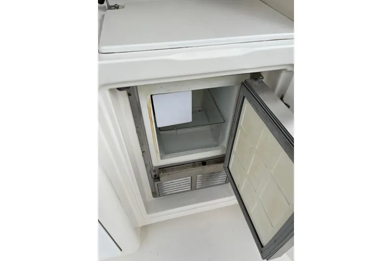 Slide: The Image of Open refrigerator on 2005 Silverton 34 Convertible boat, showcasing interior storage space. - 36