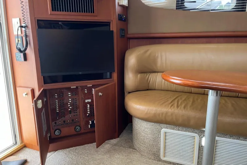 Slide: The Image of Interior of 2005 Silverton 34 Convertible yacht with TV, control panel, and leather seating. - 38