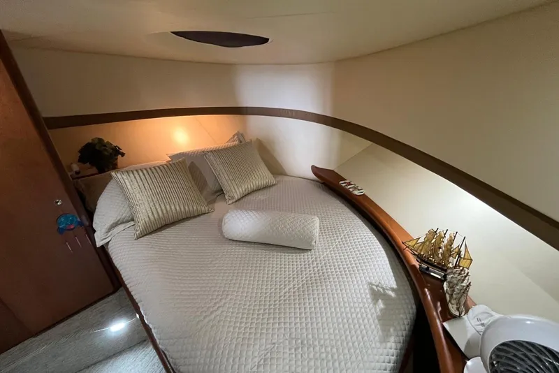 Slide: The Image of Cozy bedroom in 2005 Silverton 34 Convertible yacht with elegant decor and model ship. - 42