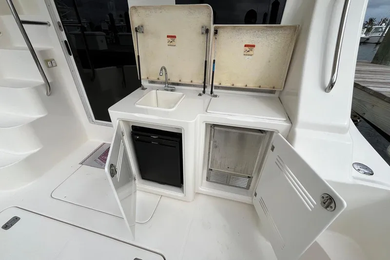 Slide: The Image of 2005 Silverton 34 Convertible yacht kitchenette with sink, storage, and mini fridge. - 43
