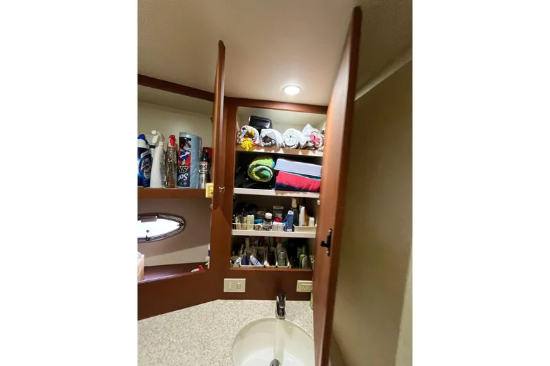 Slide: The Image of Cabinet interior on 2005 Silverton 34 Convertible yacht, stocked with toiletries and towels. - 48