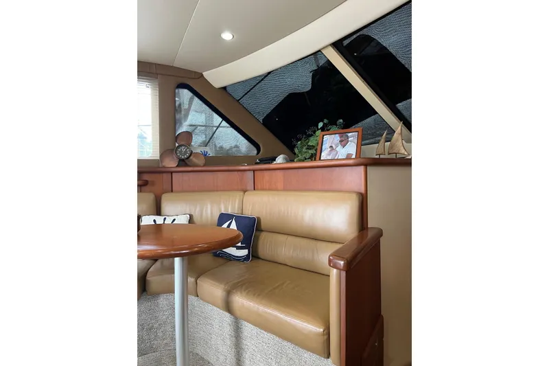 Slide: The Image of Interior of 2005 Silverton 34 Convertible yacht with leather seating and nautical decor. - 9