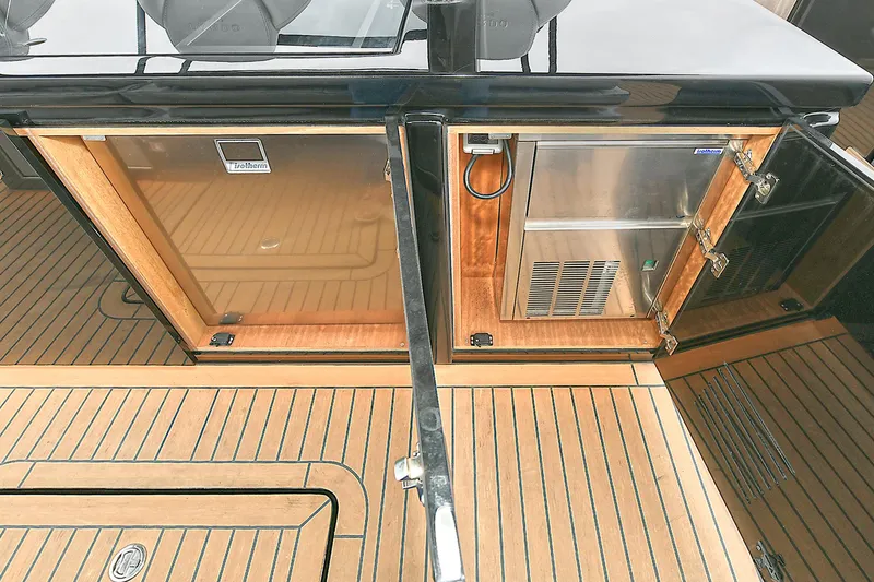Slide: The Image of 2023 Pardo Yachts 43 interior with wooden cabinetry and stainless steel appliances. - 11
