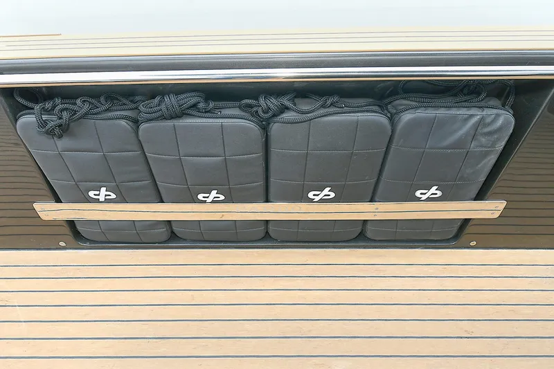 Slide: The Image of 2023 Pardo Yachts 43 storage compartment with padded fenders on teak deck. - 20