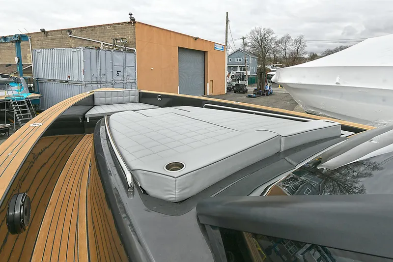 Slide: The Image of 2023 Pardo Yachts 43 with sleek deck and cushioned seating in a marina setting. - 24