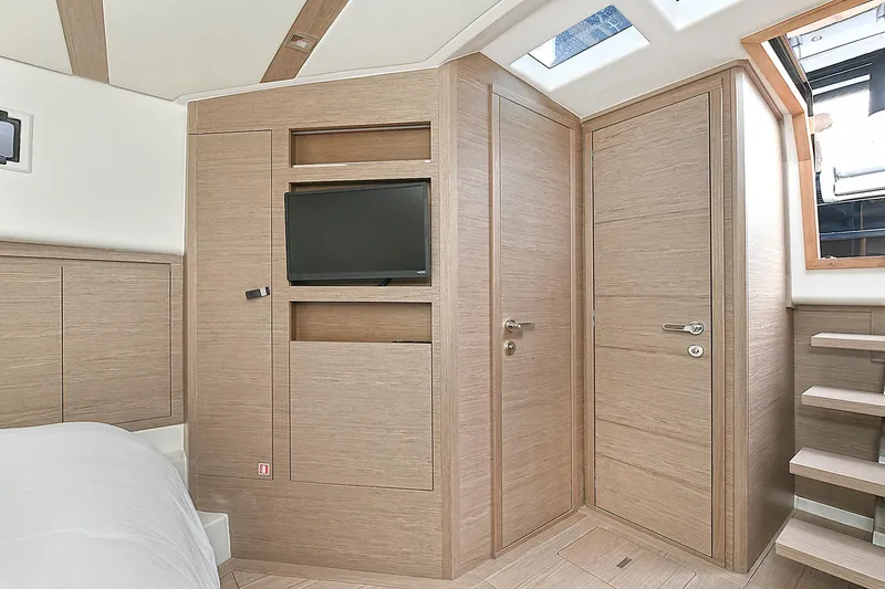 Slide: The Image of 2023 Pardo Yachts 43 interior cabin with wood finish and built-in TV. - 26