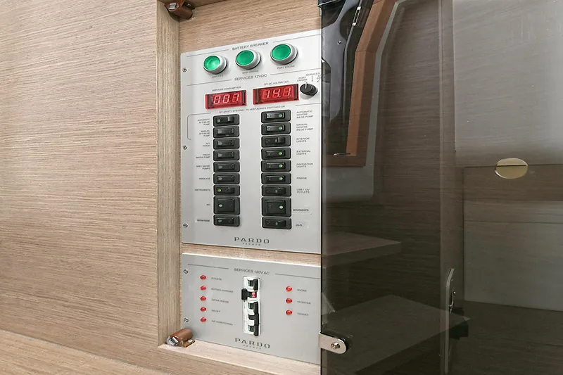 Slide: The Image of Electrical control panel on 2023 Pardo Yachts 43, featuring switches and digital displays. - 28