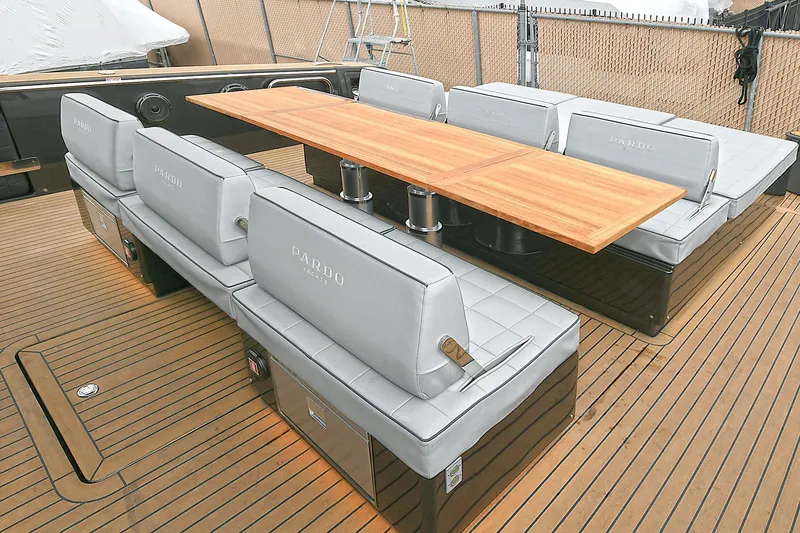 Slide: The Image of Luxury seating area on 2023 Pardo Yachts 43 with sleek wooden table. - 7