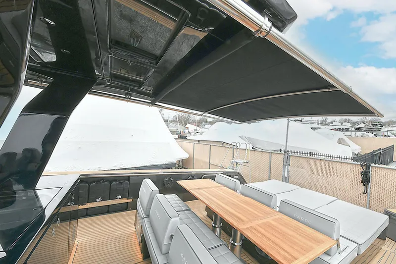 Slide: The Image of 2023 Pardo Yachts 43 interior with sleek seating and wooden table under retractable canopy. - 8