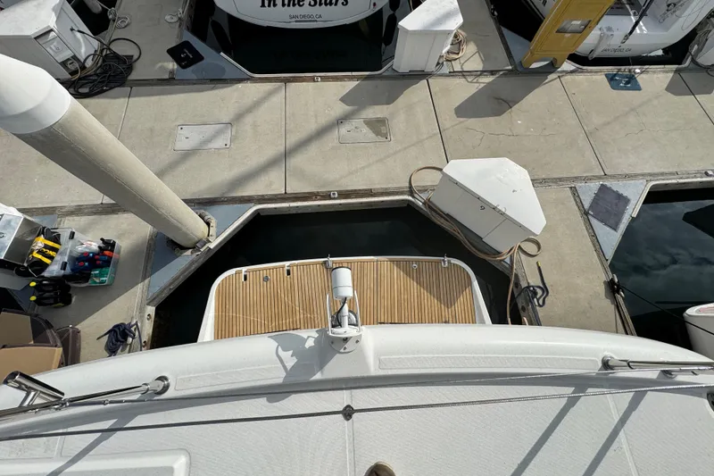 Slide: The Image of 2017 Beneteau Swift Trawler 44 docked, viewed from above, showing stern and marina surroundings. - 16