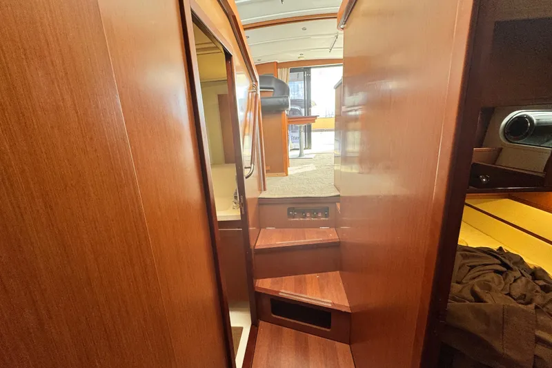 Slide: The Image of Interior view of 2017 Beneteau Swift Trawler 44 with wooden stairs and cabin. - 25