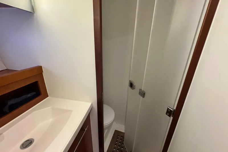 Slide: The Image of Bathroom interior of 2017 Beneteau Swift Trawler 44, featuring sink and shower area. - 26