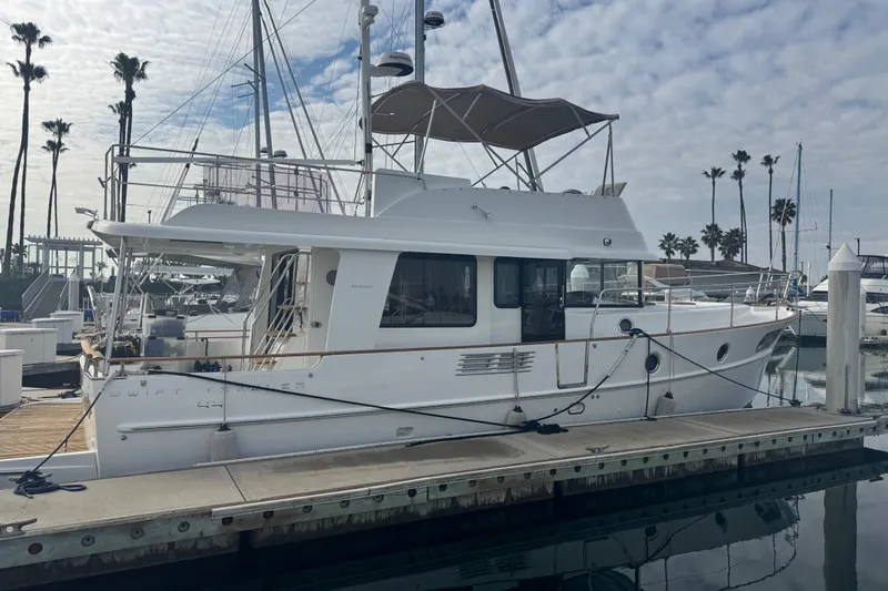 Slide: The Image of 2017 Beneteau Swift Trawler 44 docked at marina under cloudy sky. - 3