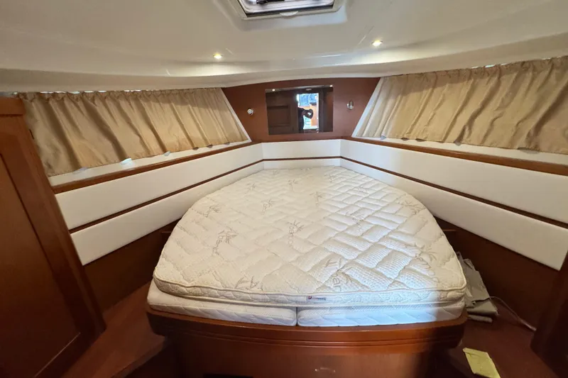 Slide: The Image of 2017 Beneteau Swift Trawler 44 cabin with comfortable bed and elegant wood finish. - 31