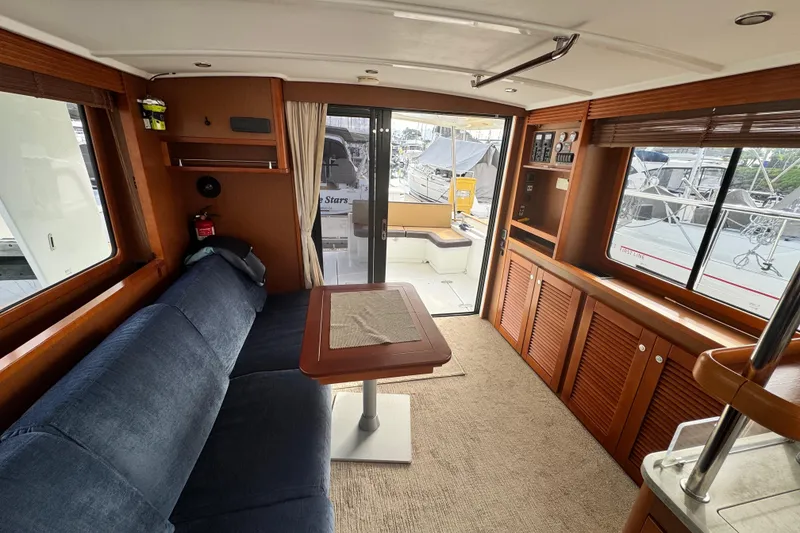Slide: The Image of Interior of 2017 Beneteau Swift Trawler 44 with cozy seating and wooden cabinetry. - 38