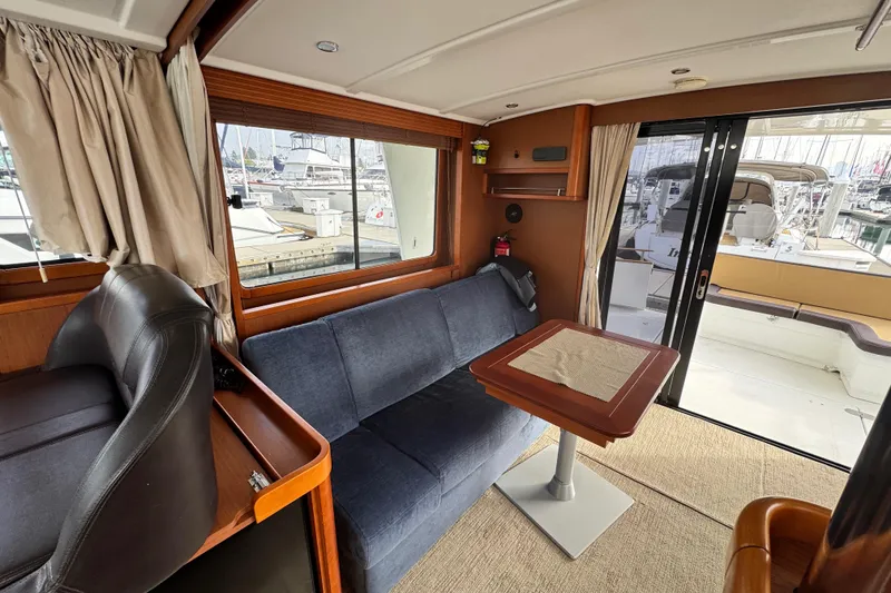Slide: The Image of Interior of 2017 Beneteau Swift Trawler 44 with seating and table, dock view. - 39