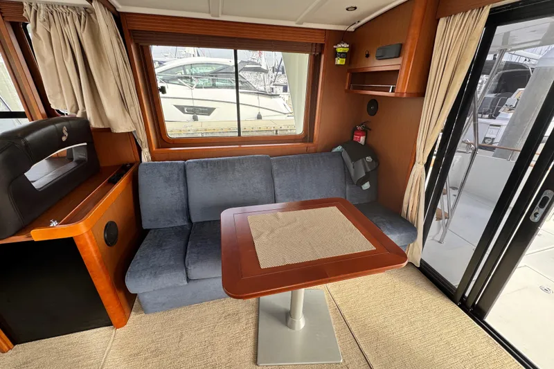 Slide: The Image of Interior of 2017 Beneteau Swift Trawler 44 with cozy seating and table. - 45