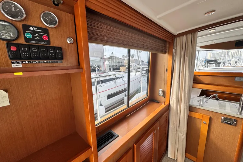 Slide: The Image of Interior view of 2017 Beneteau Swift Trawler 44, featuring control panel and window. - 47