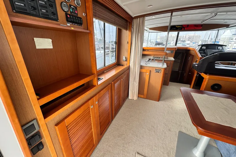 Slide: The Image of 2017 Beneteau Swift Trawler 44 interior with wood cabinetry and helm station. - 49