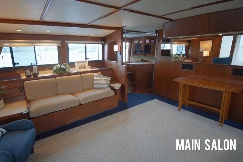Slide: The Image of Main salon of 1985 Custom 60 yacht with elegant wood interior and comfortable seating. - 12
