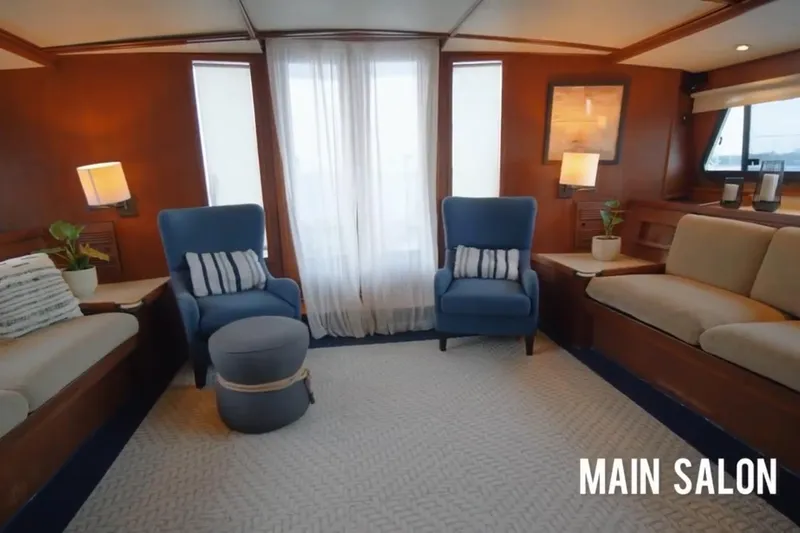 Slide: The Image of Main salon of 1985 Custom model 60 yacht with cozy seating and elegant decor. - 14