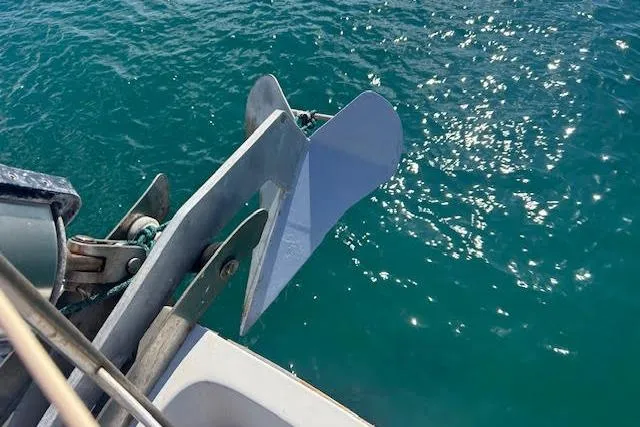 Slide: The Image of Anchor of a 1985 Custom 60 boat submerged in clear blue water. - 17